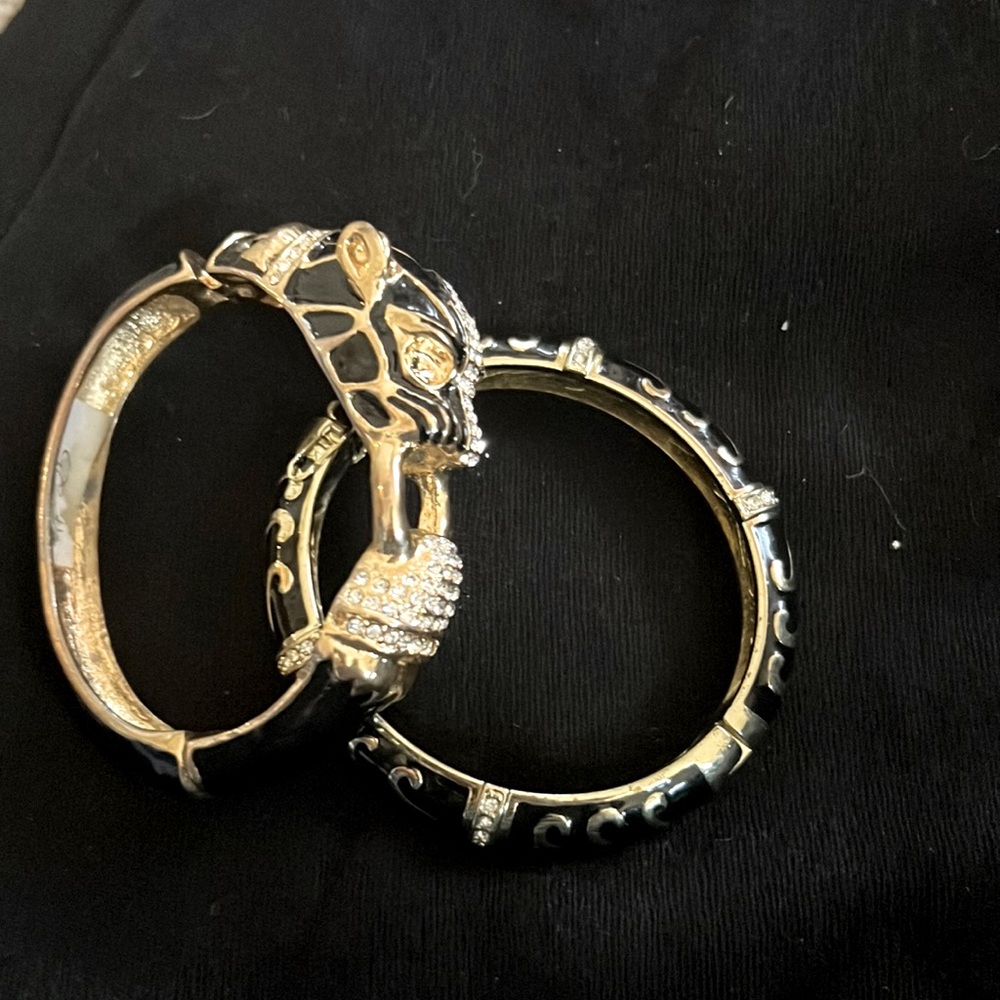 Gold and Black jeweled bracelets.